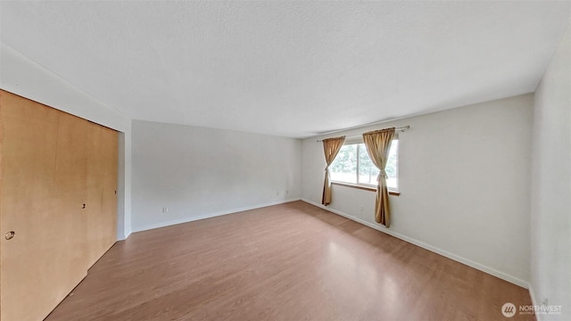 24250 164th Ave SE, Kent, WA 98042 - empty room with wood finished floors and a textured ceiling