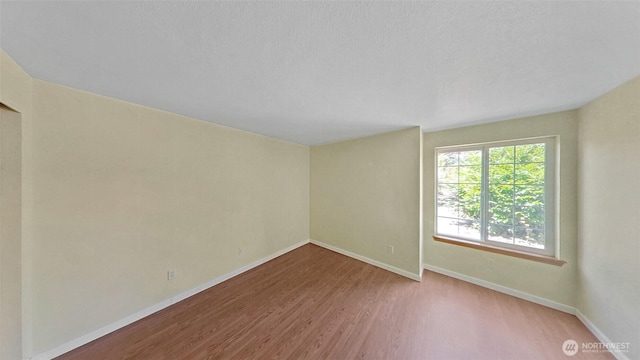 24250 164th Ave SE, Kent, WA 98042 - spare room featuring baseboards and wood finished floors
