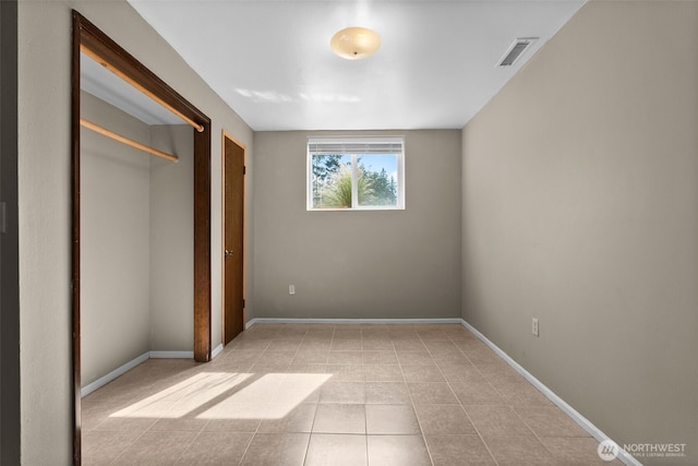 12012 County Line Rd E, Edgewood, WA 98372 - unfurnished bedroom with tile patterned floors and a closet