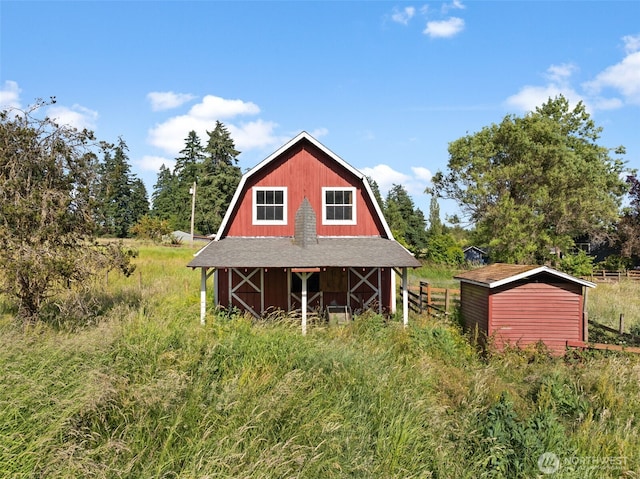 12012 County Line Rd E, Edgewood, WA 98372 - rear view of property with a gambrel roof, an outdoor structure, a barn, and roof with shingles