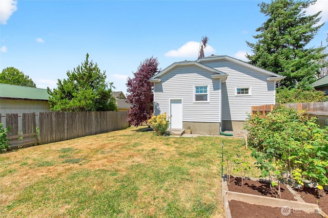 2318 F St, Bellingham, WA 98225 - back of property featuring a vegetable garden and a fenced backyard