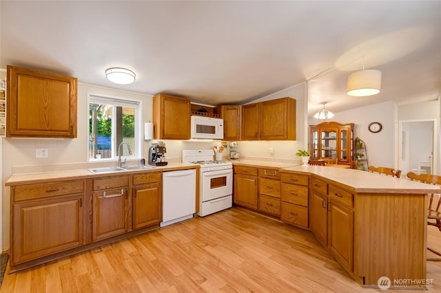 24442 Wicker Rd Unit 37, Sedro Woolley, WA 98284 - kitchen featuring white appliances, a peninsula, light countertops, light wood finished floors, and lofted ceiling
