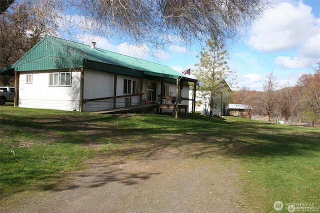 1411 Kellogg Hallow Rd, Dayton, WA 99328 - view of side of home with a yard, a metal roof, and a porch