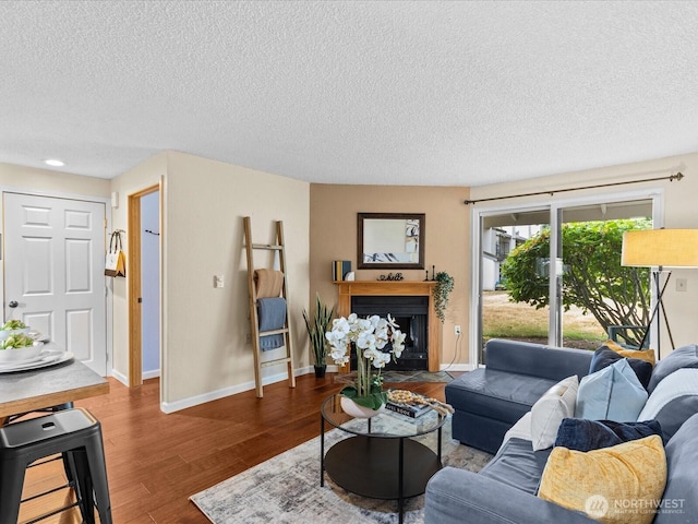 4811 76th St NE Unit 5, Marysville, WA 98270 - living room featuring a textured ceiling, wood finished floors, a fireplace with flush hearth, and recessed lighting