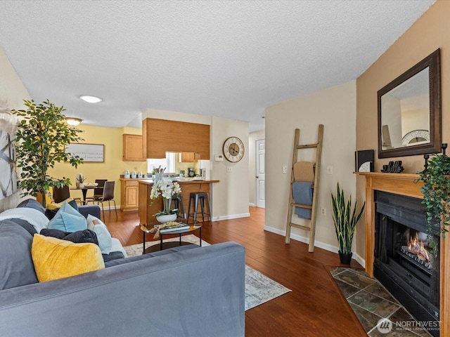 4811 76th St NE Unit 5, Marysville, WA 98270 - living room featuring dark wood finished floors, a fireplace with flush hearth, and a textured ceiling