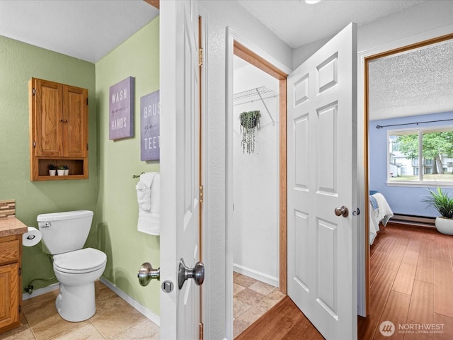 4811 76th St NE Unit 5, Marysville, WA 98270 - bathroom featuring vanity, a baseboard radiator, and a textured ceiling