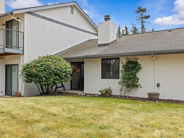 4811 76th St NE Unit 5, Marysville, WA 98270 - back of house featuring stucco siding, a yard, a chimney, and roof with shingles