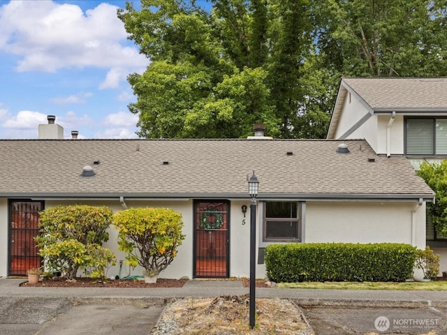 4811 76th St NE Unit 5, Marysville, WA 98270 - single story home featuring stucco siding, roof with shingles, and a chimney