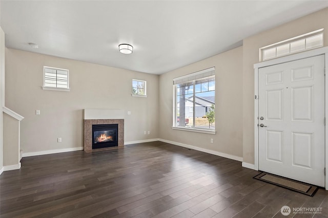 329 Holland Ave, Bellingham, WA 98226 - unfurnished living room featuring plenty of natural light, dark wood-style floors, and a tile fireplace