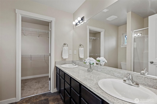 329 Holland Ave, Bellingham, WA 98226 - full bath featuring double vanity, a stall shower, a walk in closet, and stone finish flooring