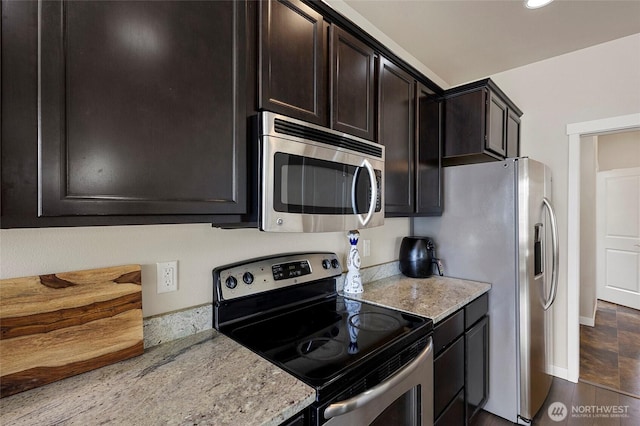 329 Holland Ave, Bellingham, WA 98226 - kitchen featuring appliances with stainless steel finishes, light stone countertops, dark brown cabinetry, and recessed lighting
