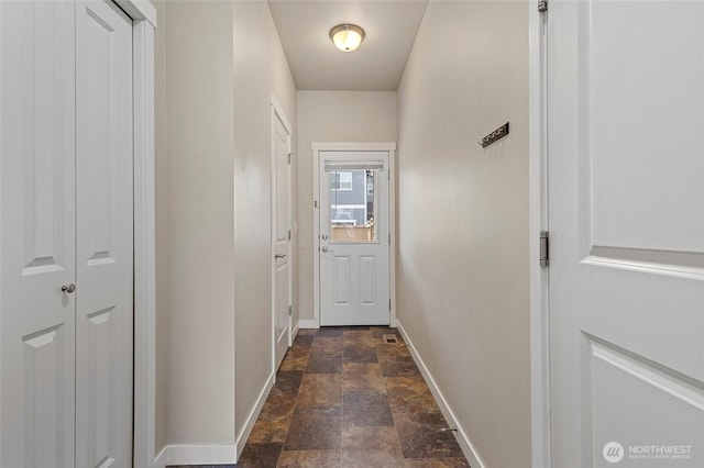 329 Holland Ave, Bellingham, WA 98226 - doorway to outside featuring baseboards and stone finish floors