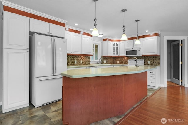 11636 25th Ave SE, Olympia, WA 98513 - kitchen featuring white appliances, white cabinetry, a center island, decorative backsplash, and glass insert cabinets