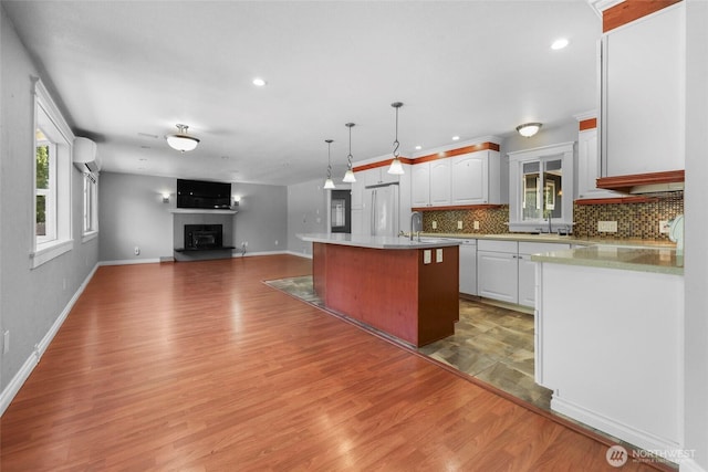 11636 25th Ave SE, Olympia, WA 98513 - kitchen with white appliances, a wall mounted air conditioner, open floor plan, decorative backsplash, and healthy amount of natural light