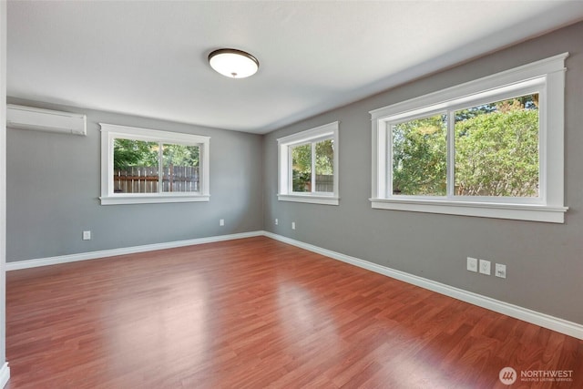 11636 25th Ave SE, Olympia, WA 98513 - spare room featuring a wall unit AC and wood finished floors