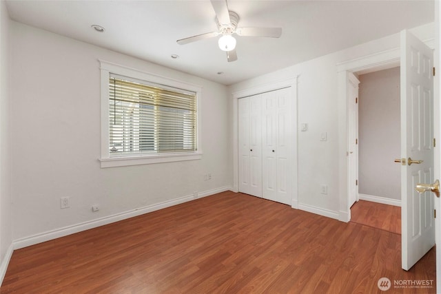11636 25th Ave SE, Olympia, WA 98513 - unfurnished bedroom with wood finished floors, a ceiling fan, and a closet
