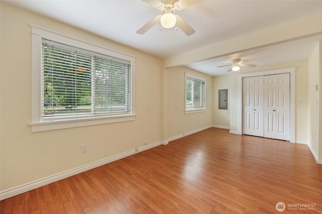 11636 25th Ave SE, Olympia, WA 98513 - unfurnished bedroom featuring electric panel, wood finished floors, a closet, and a ceiling fan