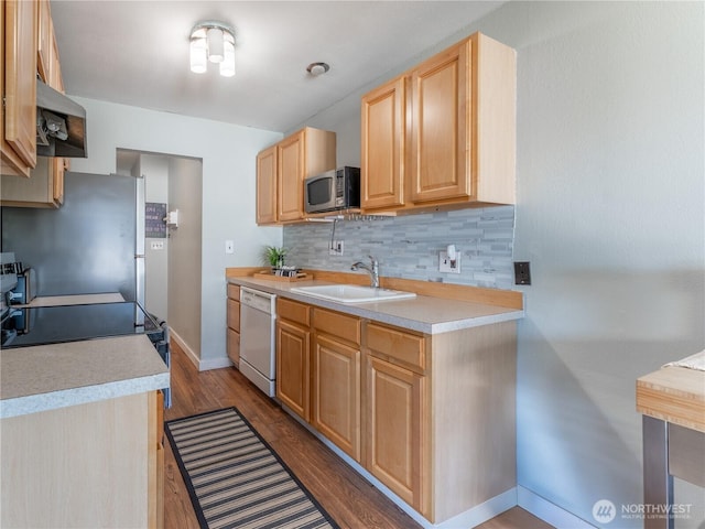 10 S Cove Ave Unit 21, Wenatchee, WA 98801 - kitchen with stainless steel appliances, light brown cabinetry, range hood, decorative backsplash, and light countertops