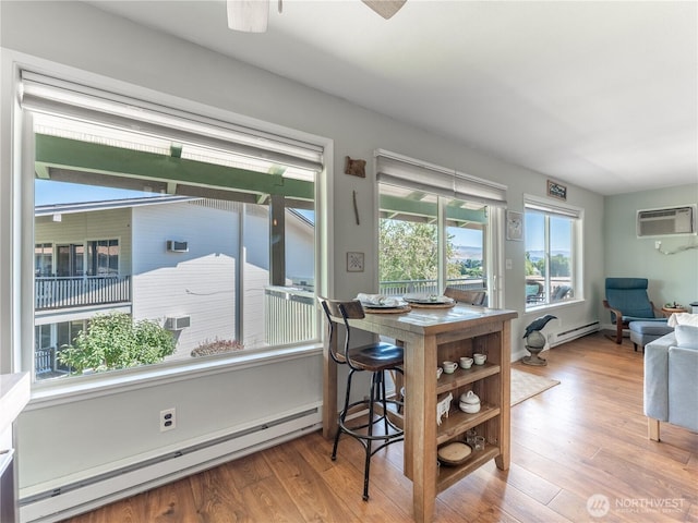 10 S Cove Ave Unit 21, Wenatchee, WA 98801 - dining area featuring a baseboard radiator, wood finished floors, and ceiling fan