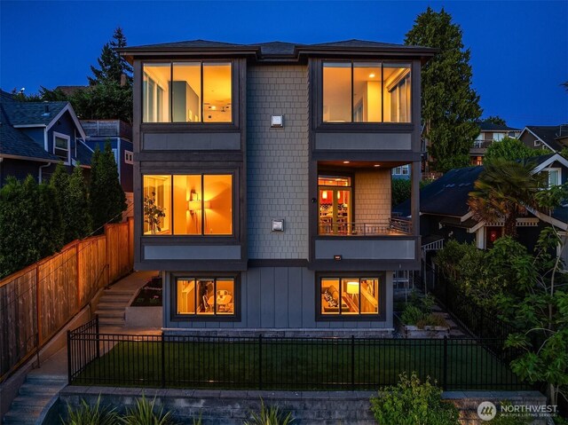 2542 12th Ave W, Seattle, WA 98119 - back of property with a balcony and a fenced front yard