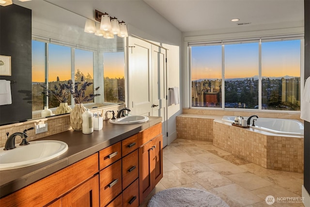 2542 12th Ave W, Seattle, WA 98119 - bathroom with plenty of natural light, double vanity, a bath, decorative backsplash, and recessed lighting