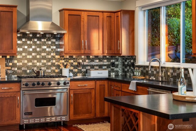 2542 12th Ave W, Seattle, WA 98119 - kitchen featuring range hood, stainless steel appliances, dark countertops, decorative backsplash, and brown cabinets