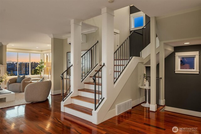 2542 12th Ave W, Seattle, WA 98119 - staircase with wood finished floors, a wall mounted air conditioner, recessed lighting, and crown molding