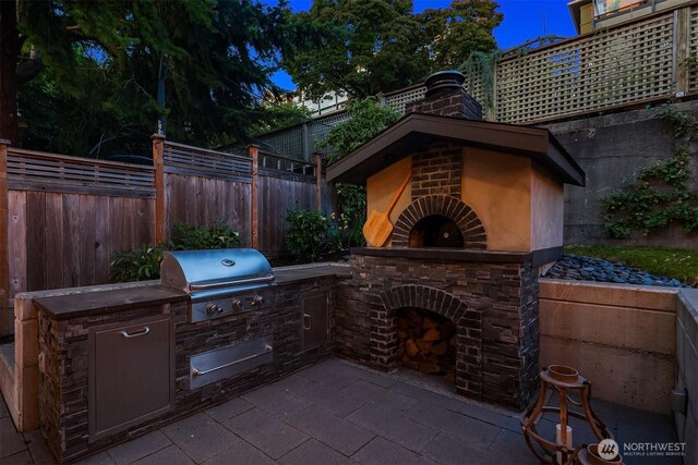 2542 12th Ave W, Seattle, WA 98119 - view of patio with an outdoor kitchen and exterior fireplace