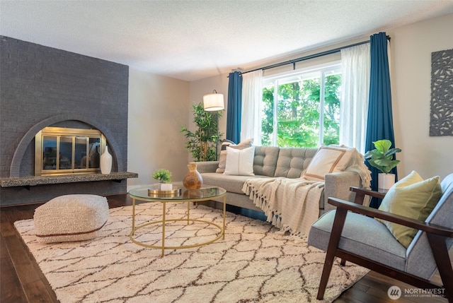 1638 Index Ave SE, Renton, WA 98058 - living room featuring hardwood / wood-style floors, a textured ceiling, and a fireplace