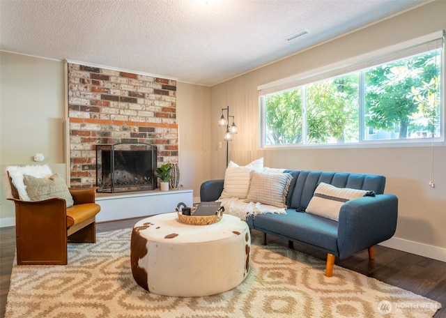 1638 Index Ave SE, Renton, WA 98058 - living area with wood finished floors, a textured ceiling, ornamental molding, and a brick fireplace