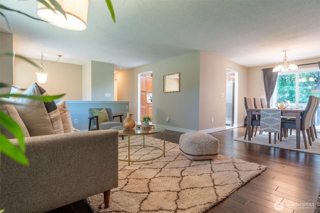 1638 Index Ave SE, Renton, WA 98058 - living room with a chandelier, hardwood / wood-style flooring, and a textured ceiling
