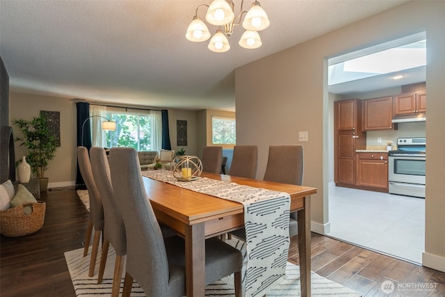 1638 Index Ave SE, Renton, WA 98058 - dining area with light wood finished floors and a chandelier