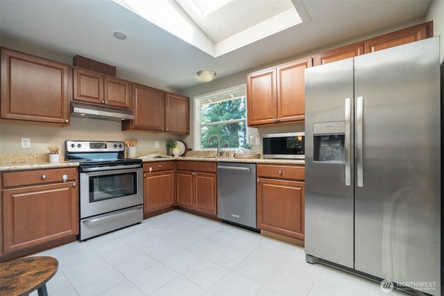 1638 Index Ave SE, Renton, WA 98058 - kitchen featuring stainless steel appliances, under cabinet range hood, and brown cabinetry