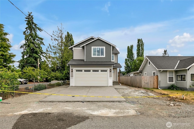608B Deeded Ln SW, Orting, WA 98360 - view of front facade with concrete driveway and an attached garage
