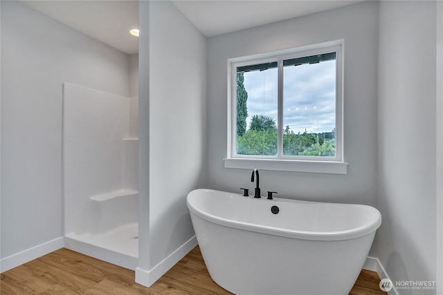 608B Deeded Ln SW, Orting, WA 98360 - full bathroom with wood finished floors, a soaking tub, and a shower