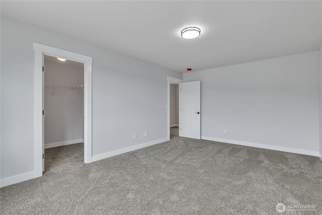 608B Deeded Ln SW, Orting, WA 98360 - unfurnished bedroom featuring carpet and a walk in closet