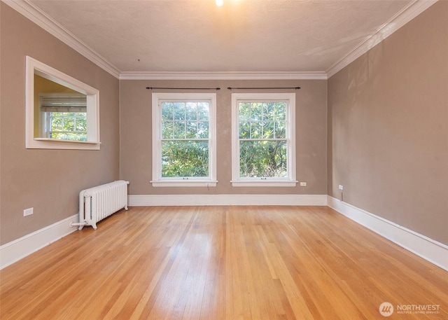 720 6th Ave Unit 206, Tacoma, WA 98405 - empty room with radiator heating unit, light wood-style flooring, and crown molding
