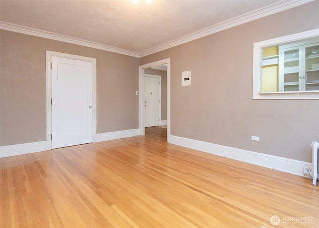 720 6th Ave Unit 206, Tacoma, WA 98405 - unfurnished room with light wood-style flooring, crown molding, and radiator heating unit