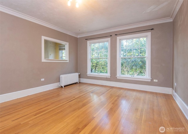 720 6th Ave Unit 206, Tacoma, WA 98405 - spare room with radiator heating unit, light wood finished floors, and crown molding