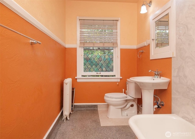 720 6th Ave Unit 206, Tacoma, WA 98405 - bathroom featuring radiator and healthy amount of natural light