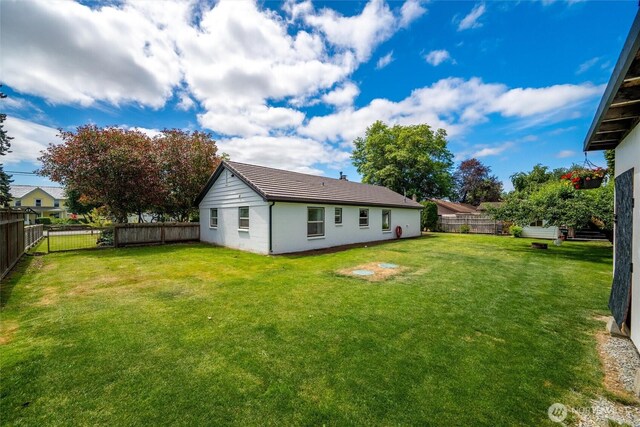 17371 Dunbar Rd, Mount Vernon, WA 98273 - back of house featuring a fenced backyard and a tiled roof