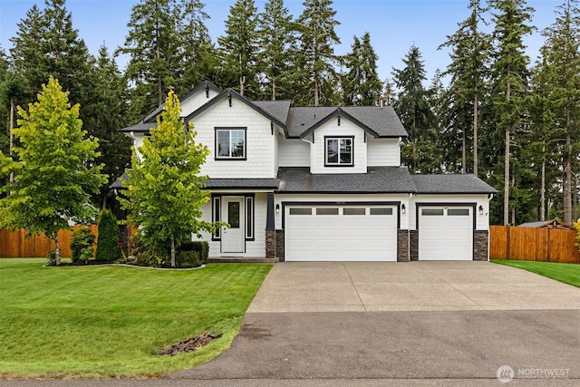 4921 Skylark St NE, Lacey, WA 98516 - view of front facade featuring concrete driveway, stone siding, roof with shingles, a garage, and an attached garage