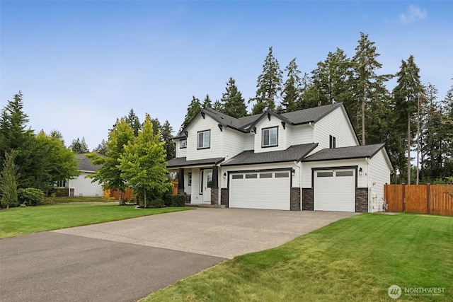4921 Skylark St NE, Lacey, WA 98516 - view of front of house featuring concrete driveway, stone siding, an attached garage, and a shingled roof