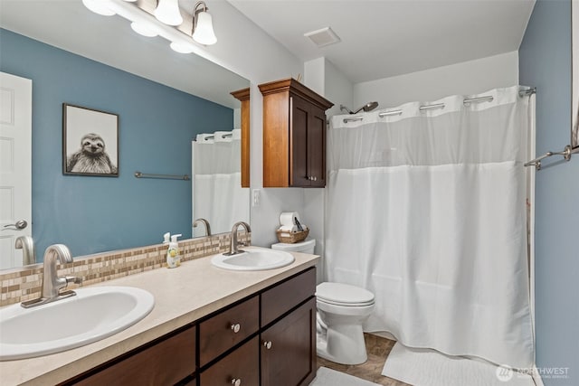 4921 Skylark St NE, Lacey, WA 98516 - full bathroom with double vanity, curtained shower, and decorative backsplash