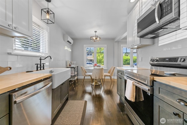 709 7th St SW, Puyallup, WA 98371 - kitchen featuring stainless steel appliances, butcher block counters, and tasteful backsplash
