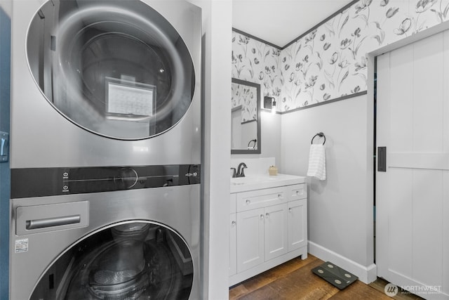709 7th St SW, Puyallup, WA 98371 - washroom with stacked washer and clothes dryer, dark wood-type flooring, and wallpapered walls