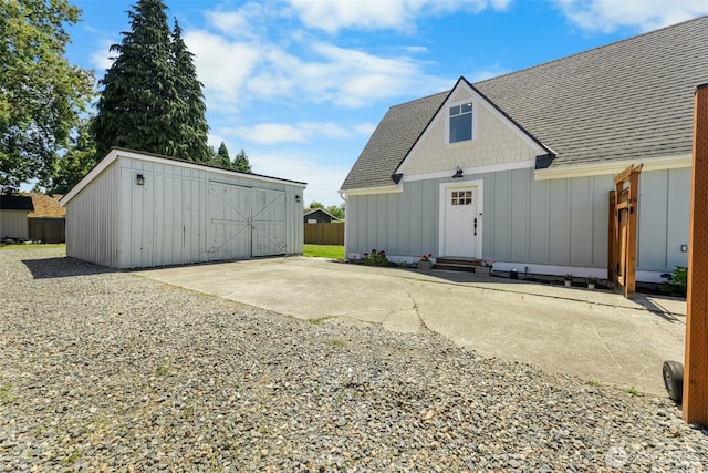 709 7th St SW, Puyallup, WA 98371 - view of front facade with board and batten siding, an outbuilding, and a shingled roof