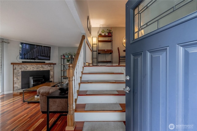 916 N 165th St Unit 7, Shoreline, WA 98133 - stairs featuring wood finished floors and a fireplace