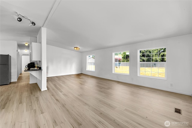 241B Foster Creek Rd, Toledo, WA 98591 - unfurnished living room with rail lighting and light wood-style flooring