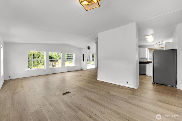 241B Foster Creek Rd, Toledo, WA 98591 - unfurnished living room featuring vaulted ceiling and light wood-style floors